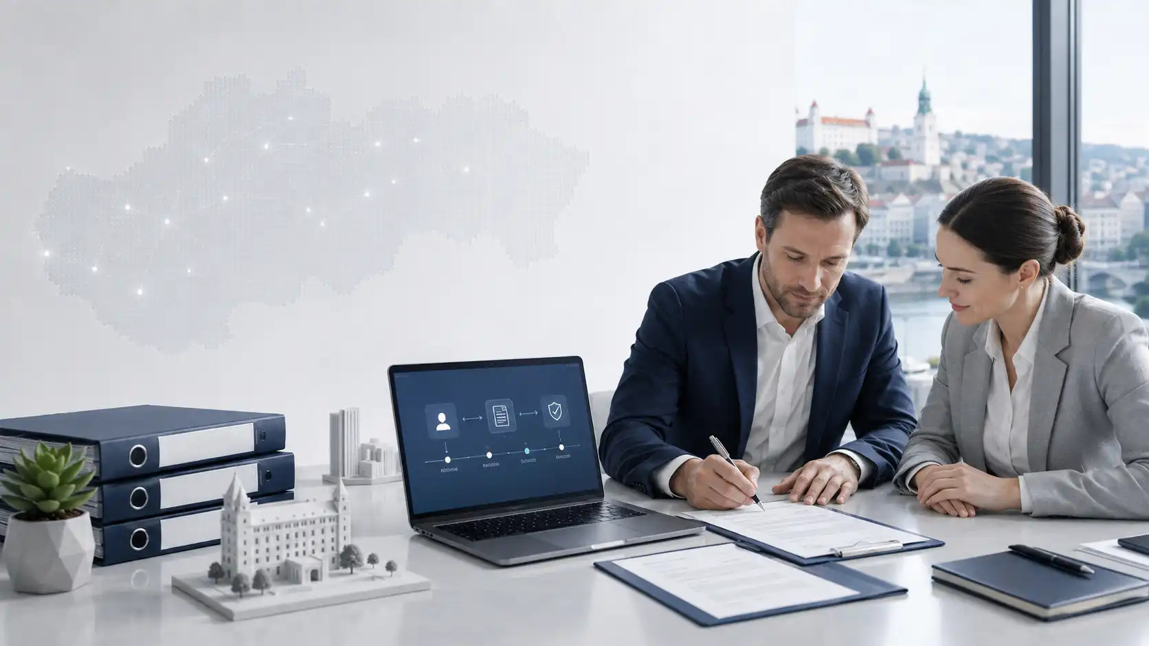 Two businesspeople are sitting at a table signing documents, with a laptop displaying the company’s graphical user interface in front of them.