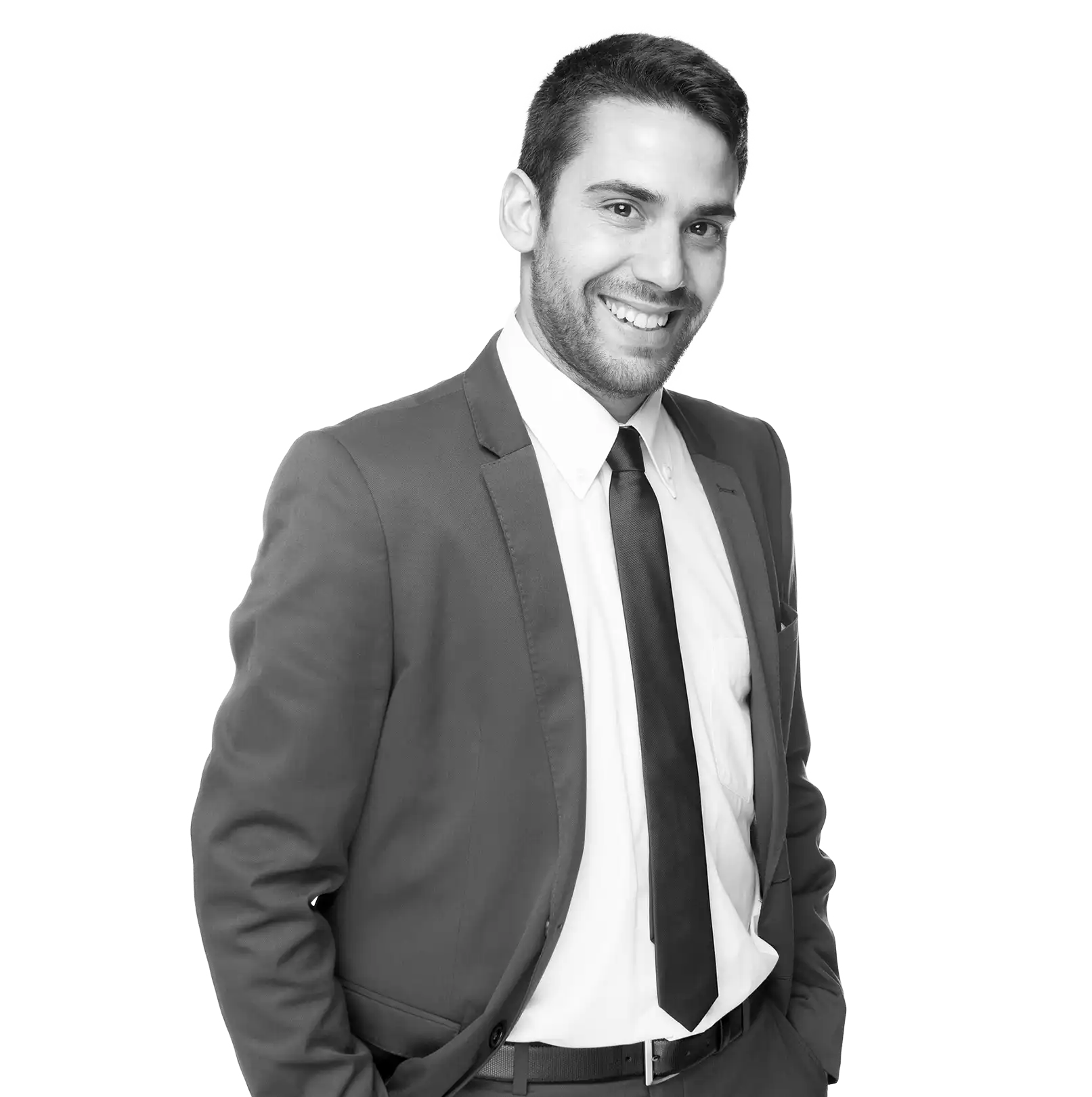 A smiling man in a suit and tie, a portrait against a black background, half-length.